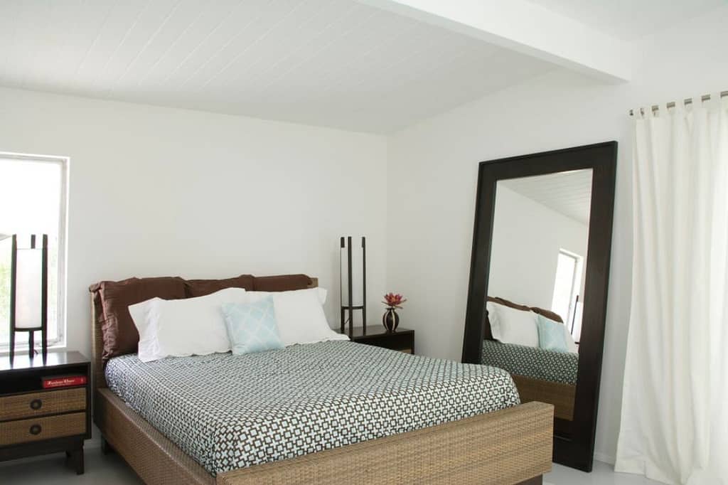 Mirror next to bed to reflect any natural light and create a brighter bedroom