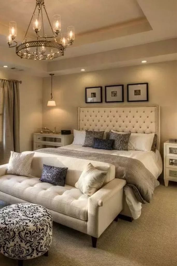 White bedroom sofa placed at the foot of a white bedroom to create a luxurious look