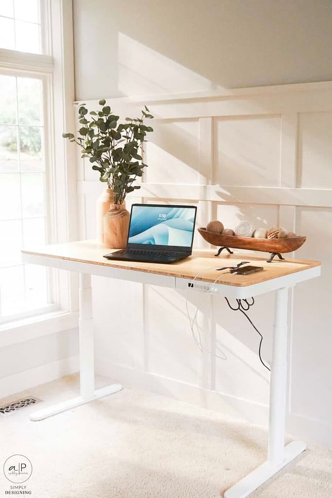 Beige stand up desk being illuminated by bedroom natural light