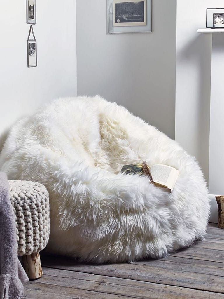 White fuzzy bean bag chair used as types of bedroom furniture for seating