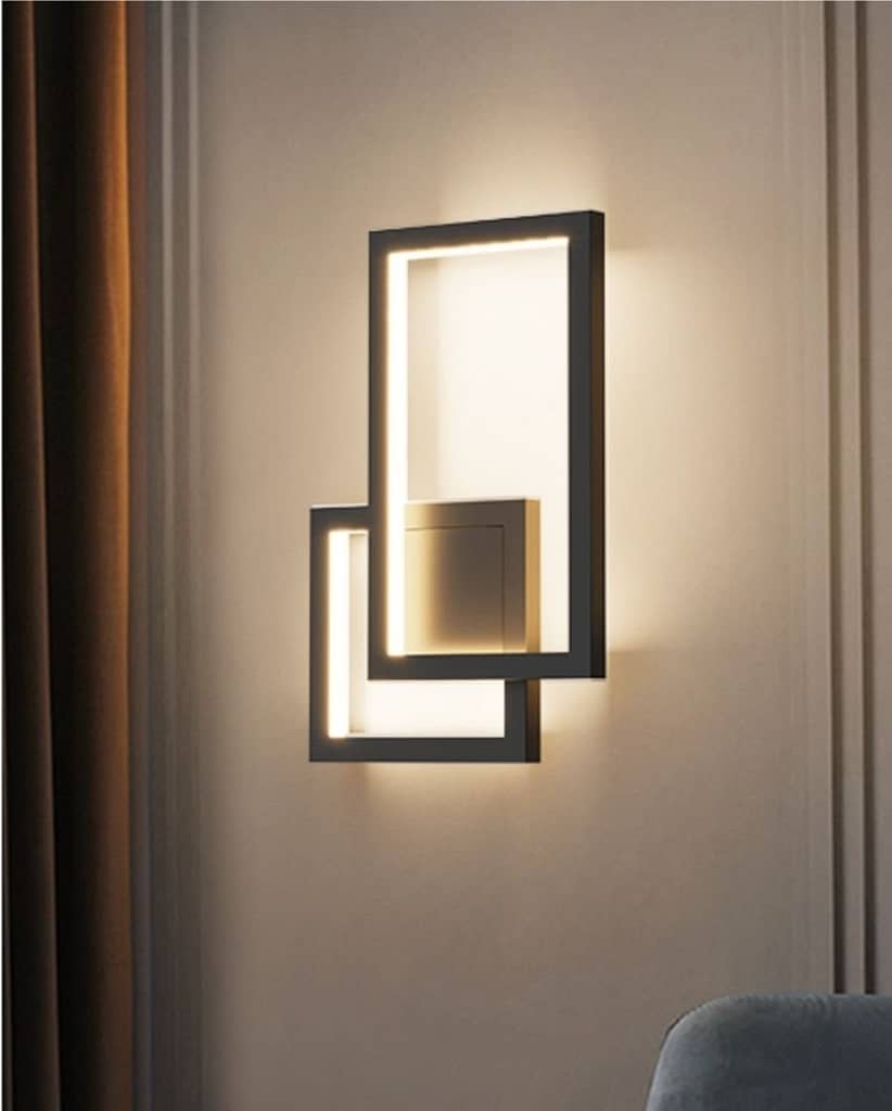 Close up of a wall sconce lighting up on a beige wall