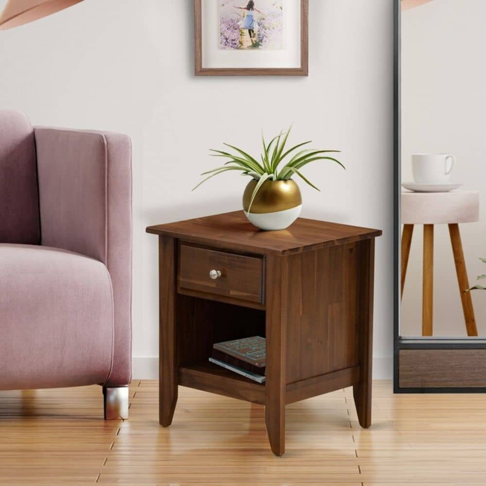 Small one drawer nightstand made out of walnut wood in a living room with a sofa