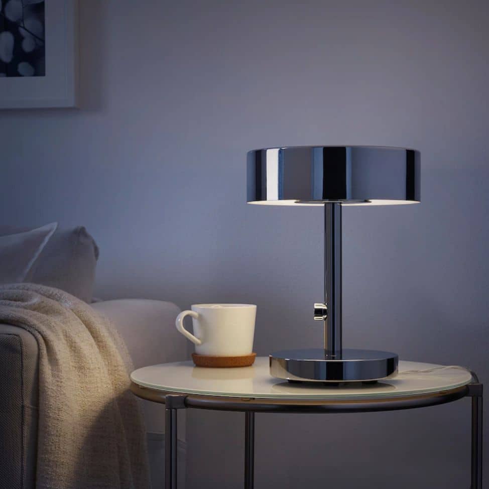 Clean bedside table with only one modern lamp and coffee cup