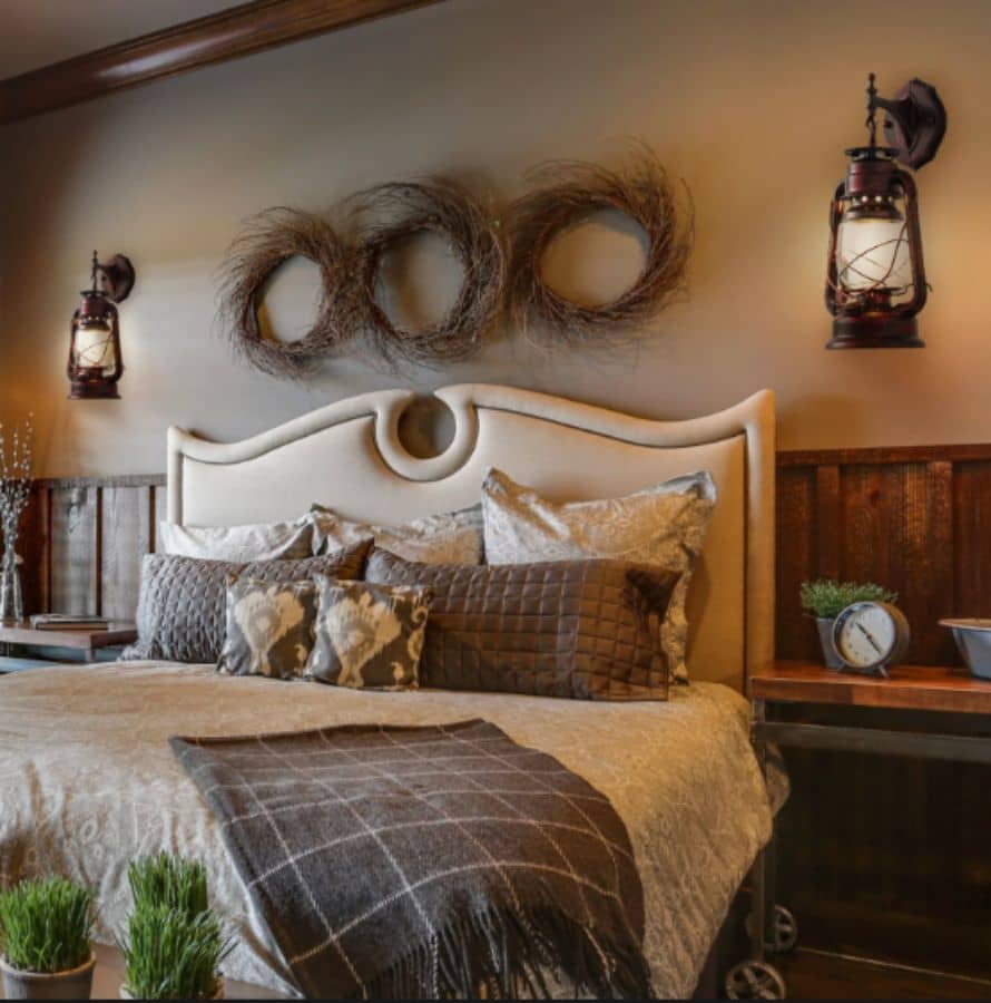 Traditional rustic wall sconces next to bed with dim lighting