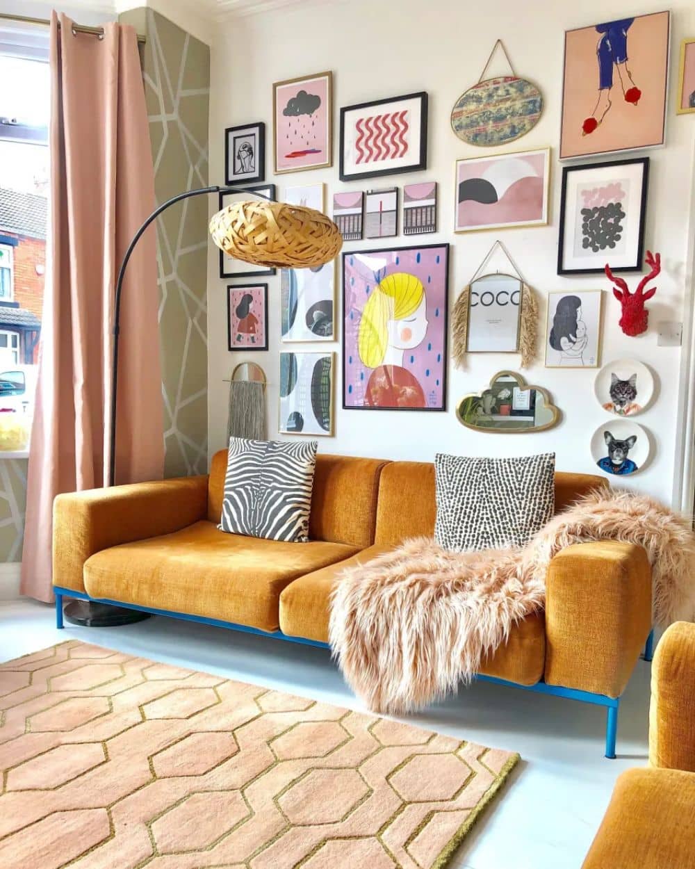 Eclectic gallery wall idea in living room with an orange sofa