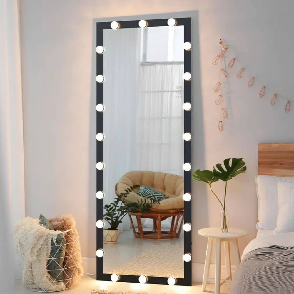 Black full-length mirror with string lights around it in a bedroom decor idea