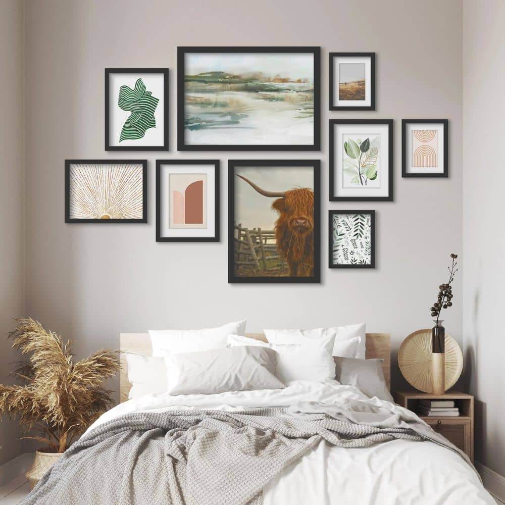 A statement piece gallery wall covering the entire white wall of a bedroom