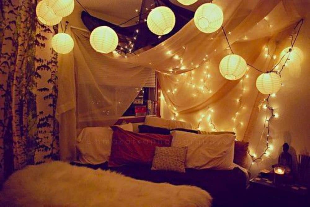 Light up paper lanterns across the ceiling of a bedroom creating cozy bedroom lighting