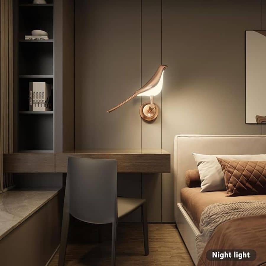 Bird shaped best bedroom wall light glowing above a bedroom